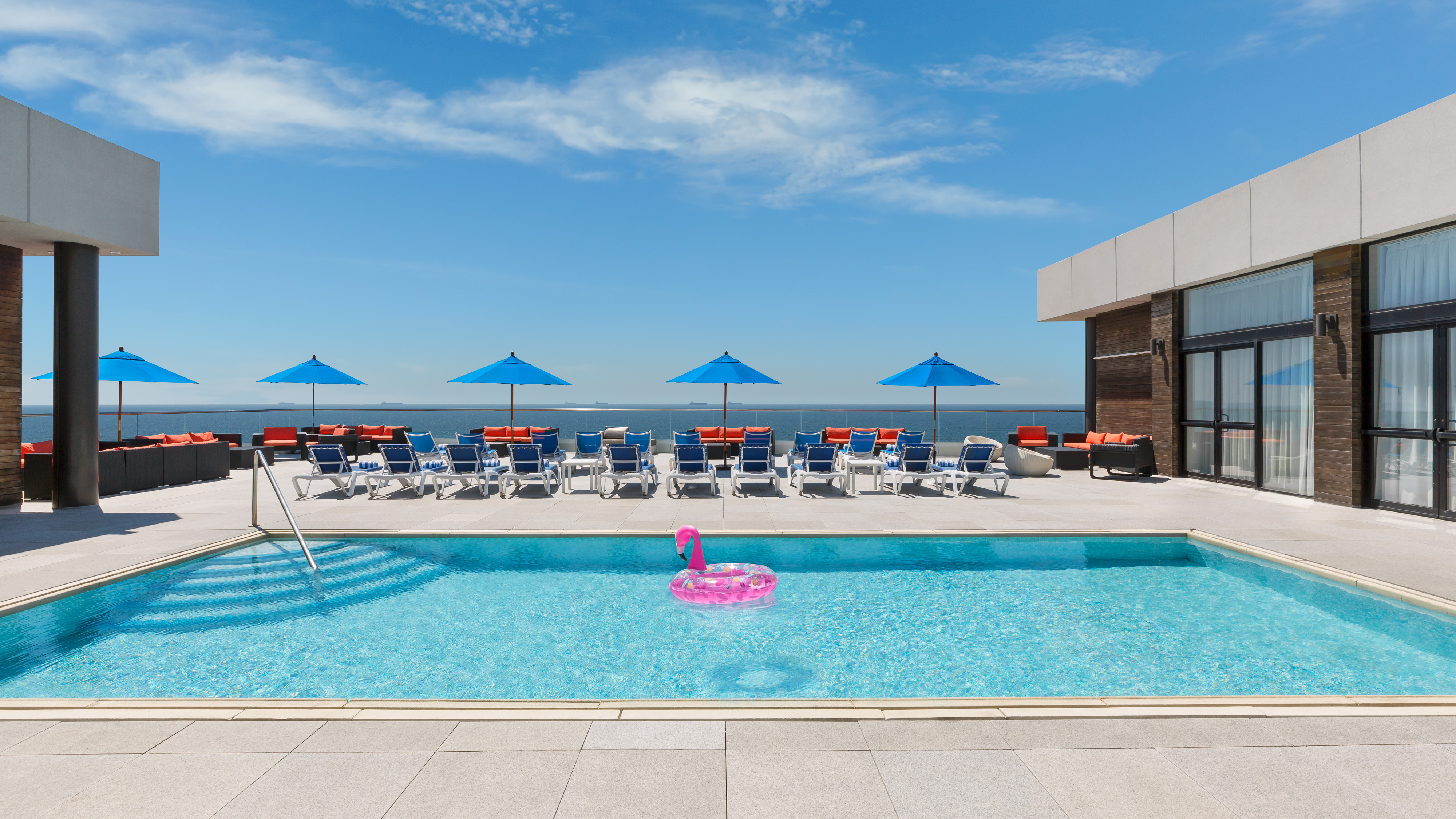 People Lounging in Beach Chairs on Roof